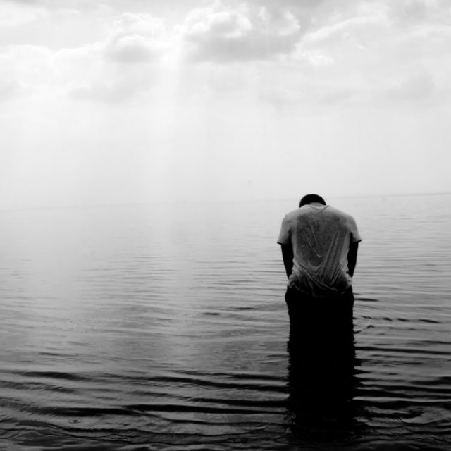 grayscale photography of person on beach